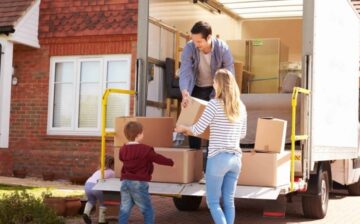 family unloading moving boxes