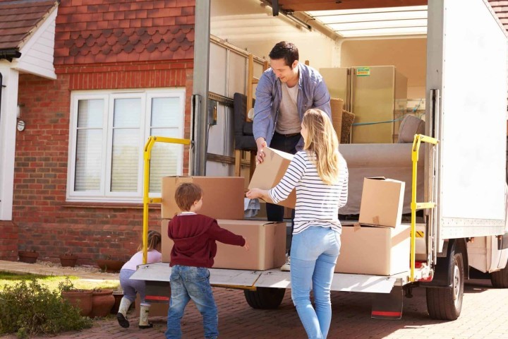 family unloading moving boxes