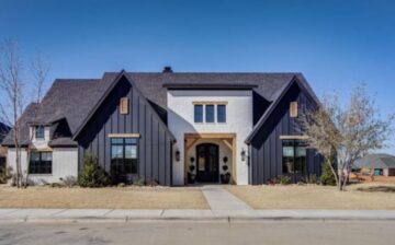 front of a one-story house with desert landscape