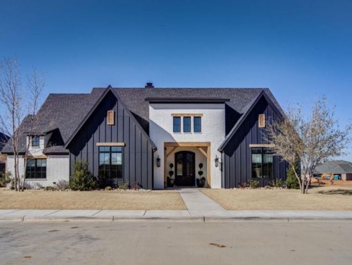 front of a one-story house with desert landscape