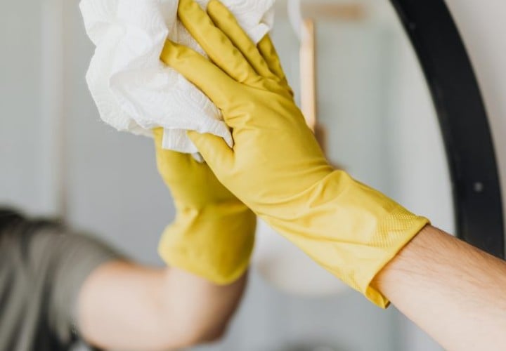 disinfecting a wall mirror