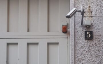 external CCTV security camera next to a door