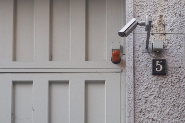 external CCTV security camera next to a door