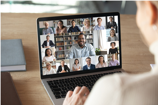 person having video conference on laptop with other people