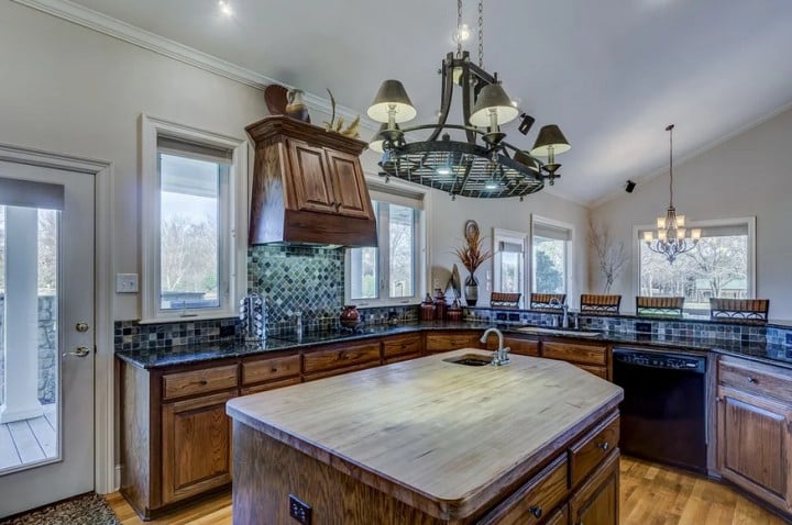 elegant kitchen with wood cabinets and floor