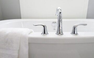 image of bathtub with towel draped on edge