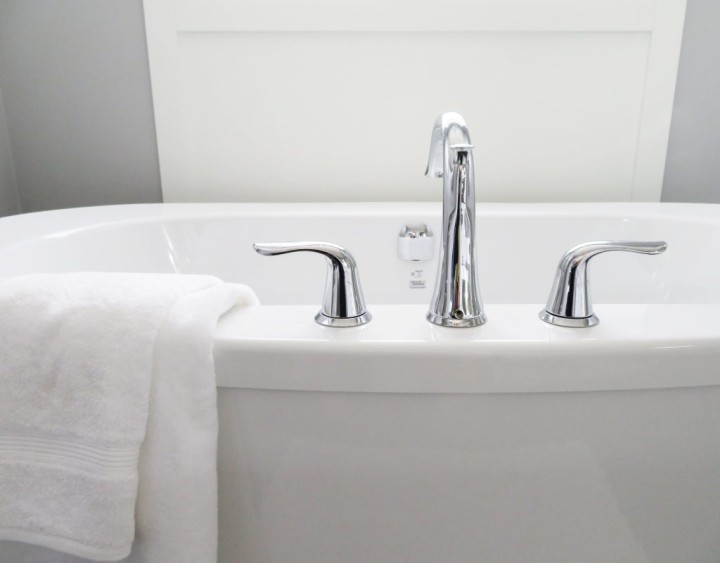 image of bathtub with towel draped on edge