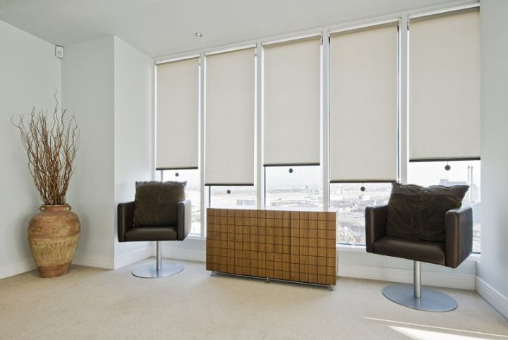 recreation room with roller blinds over the windows