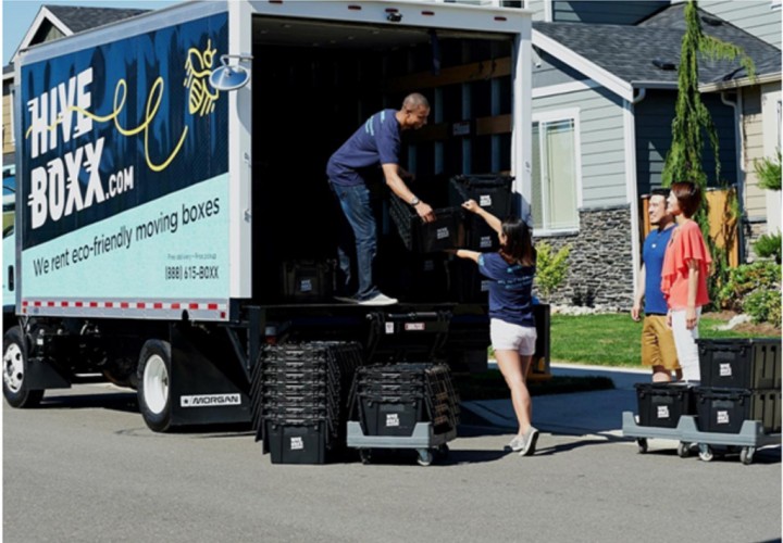 family helping movers load furniture on a truck