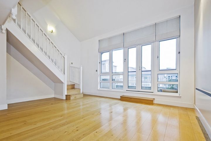 empty room with wood floor and roller blinds over the windows