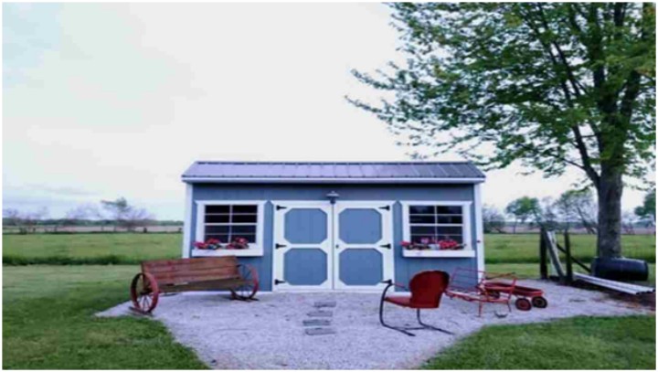 cottage-like shed in open countryside with chairs in front