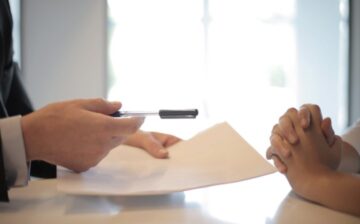 hands for signing a paper