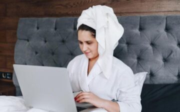 woman with computer working at home in bed