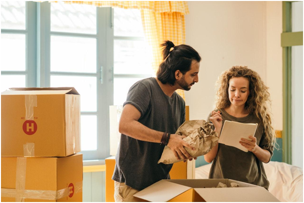 couple packing items in boxes