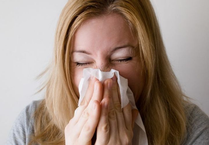 woman sneezing