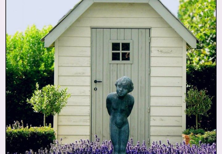 garden shed with statue in front