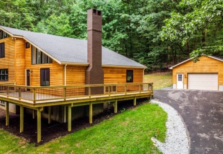 house with wood siding by a forest