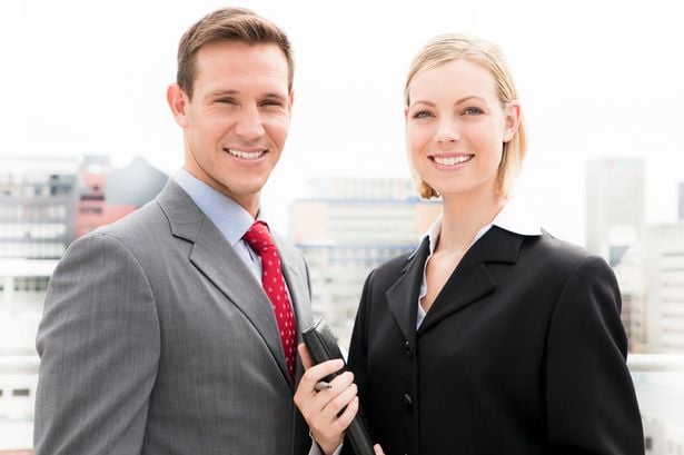 real estate agents with city in background