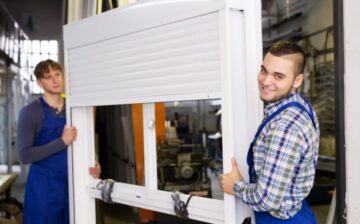 man and woman carrying roller shutter