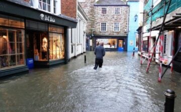 man wading on a flooded city street