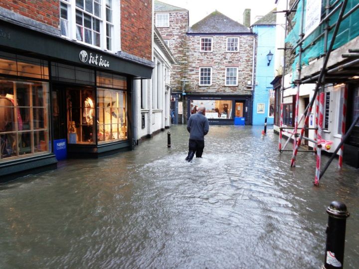 man wading on a flooded city street