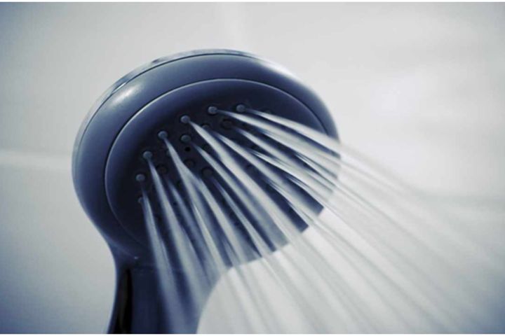 clean shower head with running water