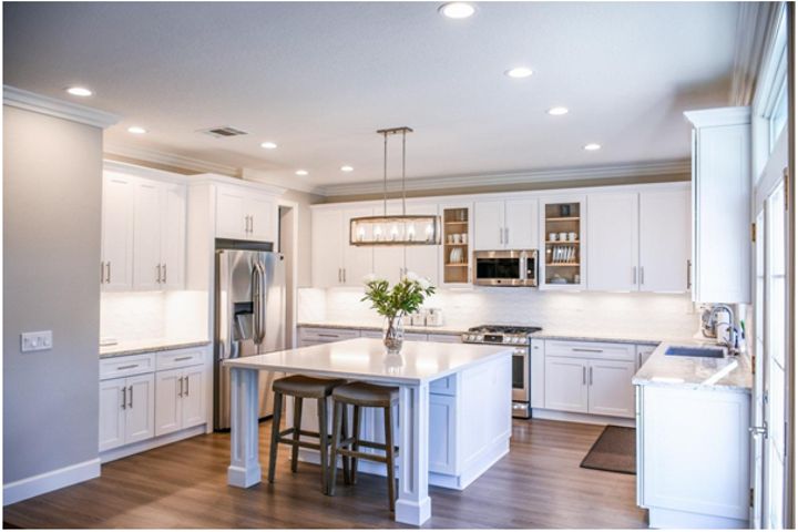 kitchen decorated in white and island in the middle