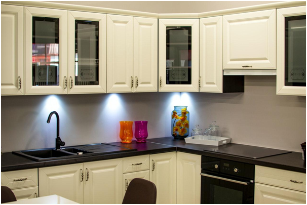 kitchen with white cabinets and black countertops and fixtures