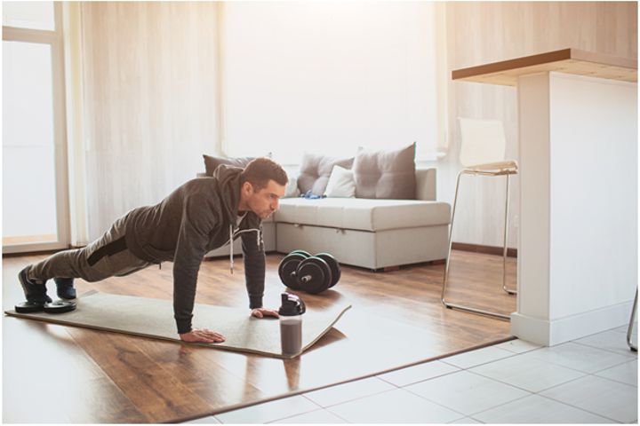 man doing plank training at home