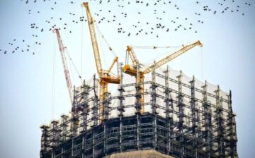 cranes on a skyscraper under construction