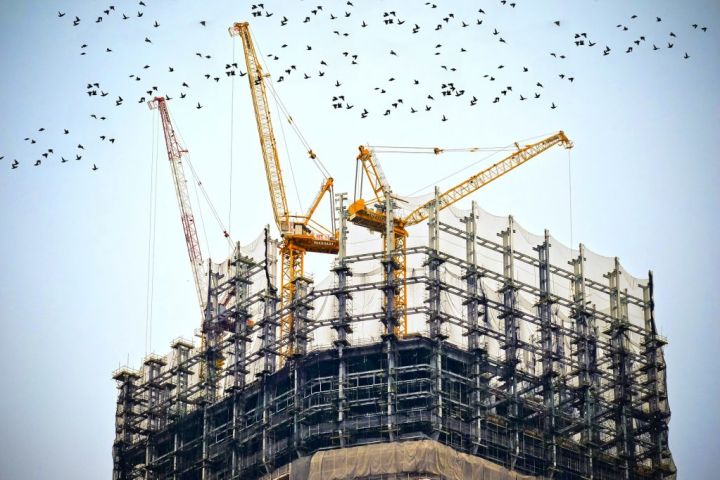 cranes on a skyscraper under construction