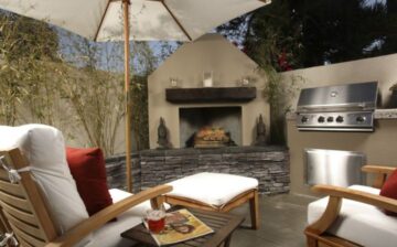 patio with furniture, umbrella, fireplace, and grill