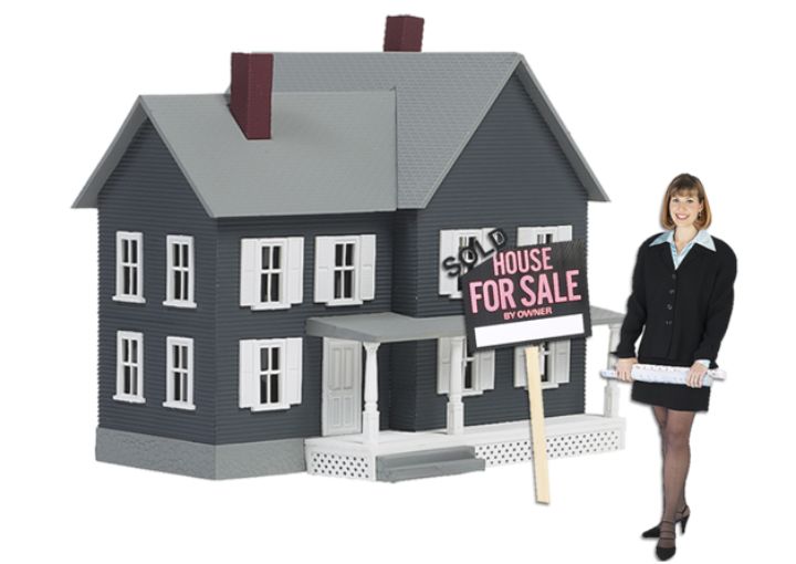 realtor in front of model of home for sale