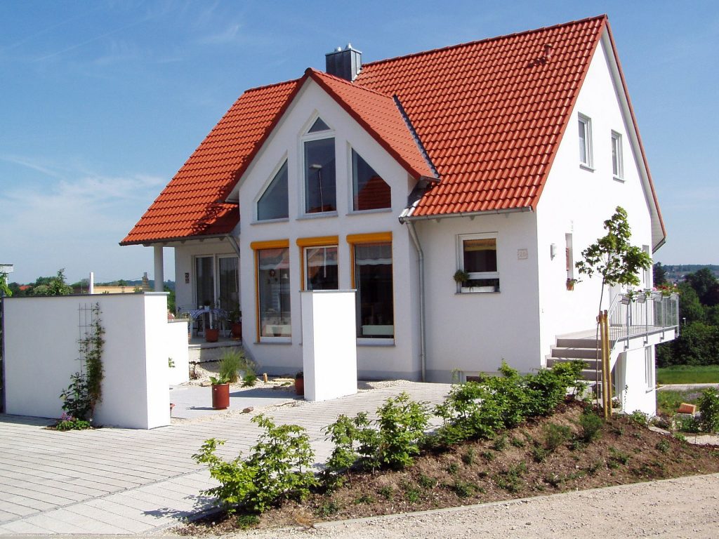 house with white sides and red roof