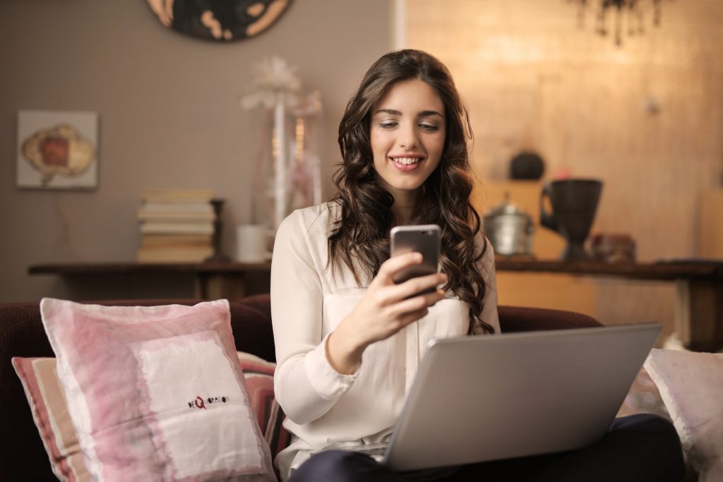 Woman with Phone and Laptop