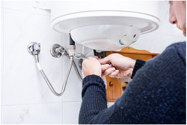 plumber connecting a water heater