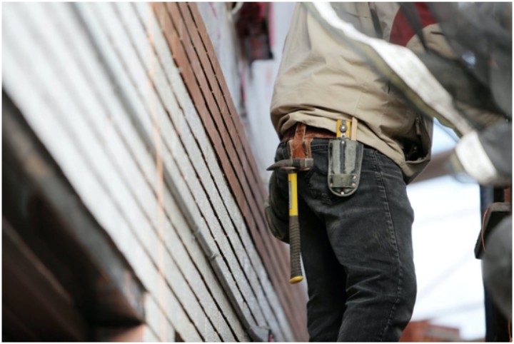 plumber at work outside a house