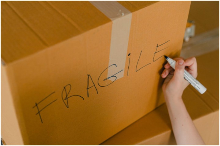 writing fragile on side of a box