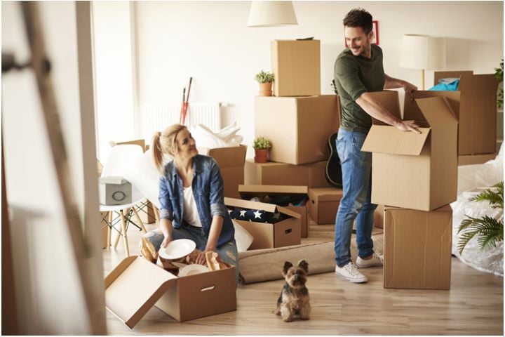 couple unpacking moving boxes