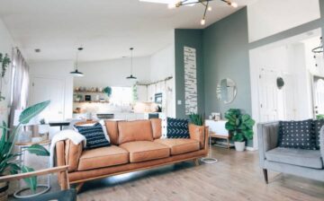 large dining room decorated in green with brown armchair