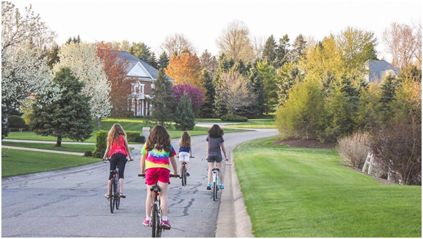 kids riding bikes on a suburban street