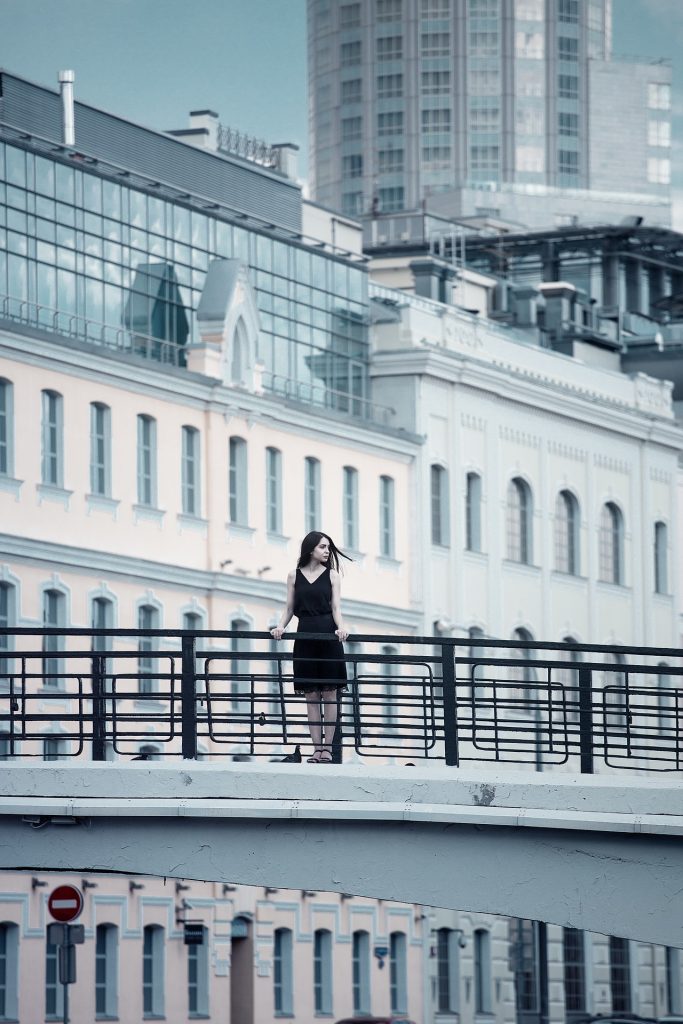 woman on bridge in foreign city