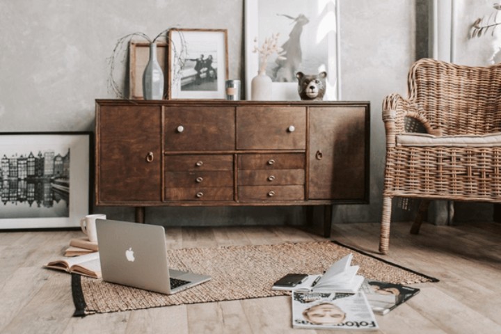 sitting room with dresser, chair, and pictures