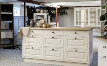 large kitchen with island and display cabinet in background