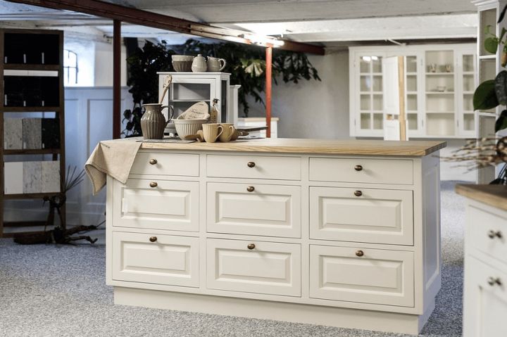 large kitchen with island and display cabinet in background