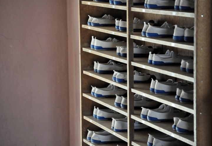 pairs of identical shoes in a cabinet