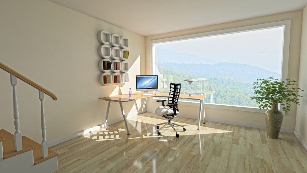 room with large window, stairway, and table