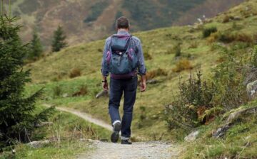 man walking in field