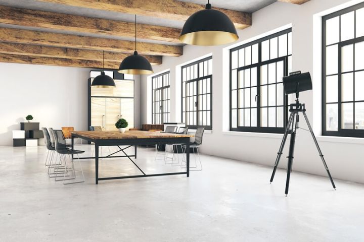 warehouse studio with table, chairs, and concrete floor