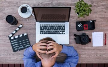 stressed employee sitting in front of a laptop